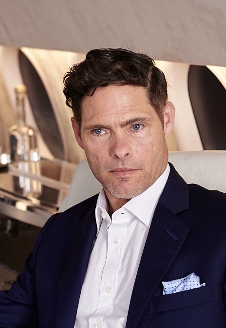 Alex Reece in a navy suit