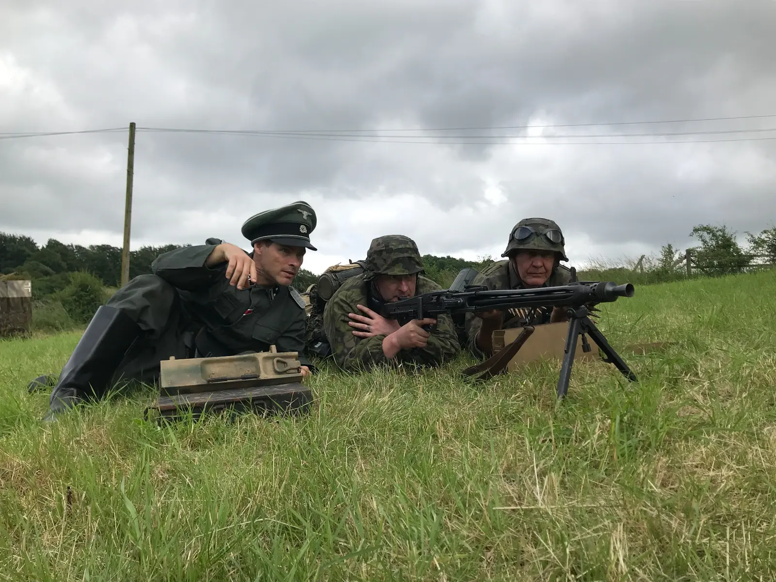 Alex Reece as The Captain with performers during a field sequence