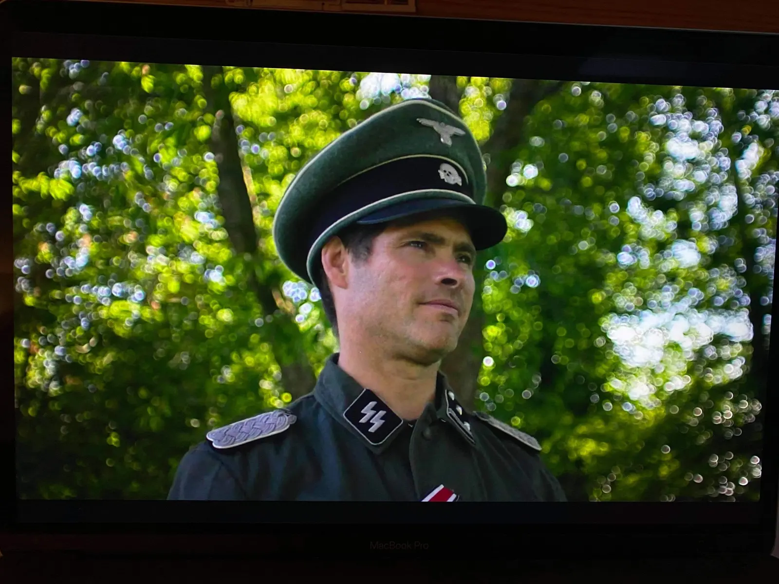 Screen image of Alex Reece as The Captain in The Aryan Papers