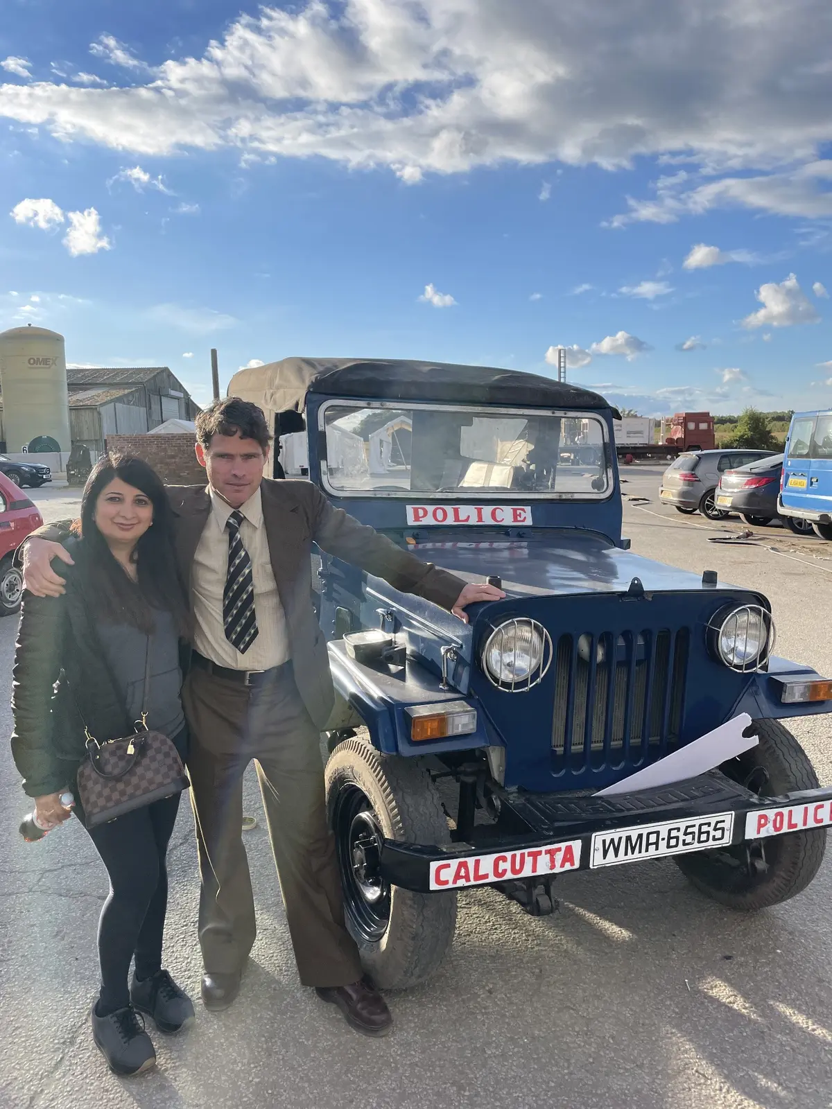 Alex Reece with a production colleague beside a period police jeep